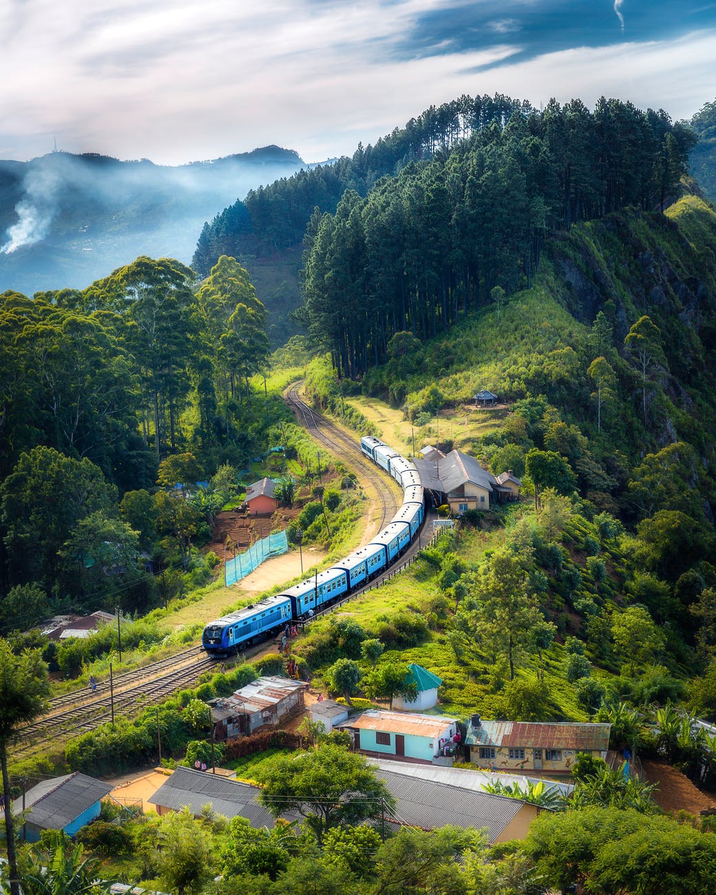 photo of railway on mountain near houses